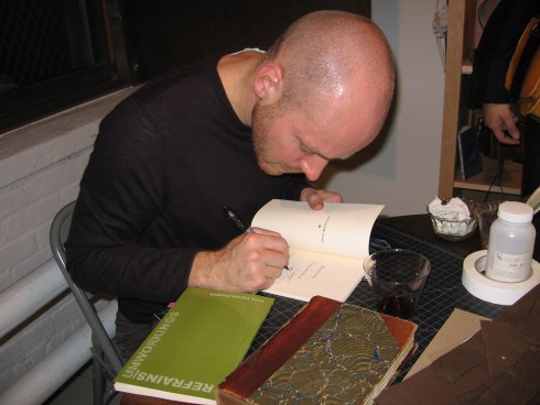 The Poet Signing Books